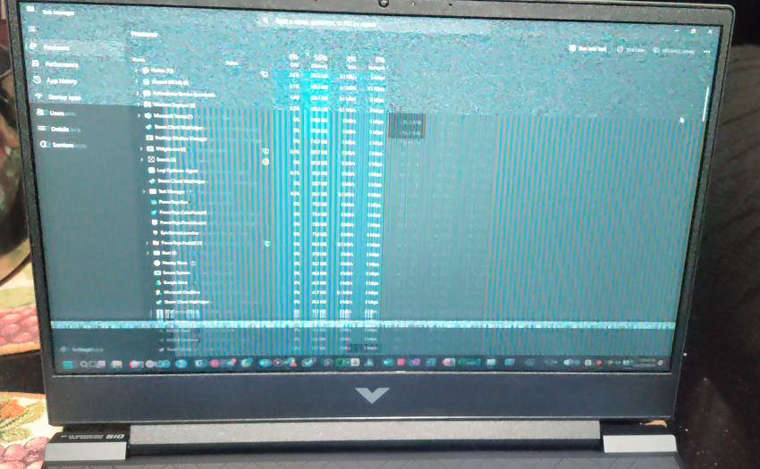 picture of a laptop, with a glitched up screen.